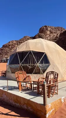 a group of chairs and a tent in the desert at NOVA lUXURY CAMP in Wadi Rum