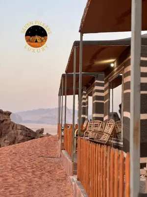 a building with wicker chairs on the beach at Seven Pillars Luxury Camp in Wadi Rum