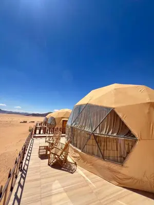 a row of tents in the middle of the desert at Noor Luxury Camp Wadi Rum in Wadi Rum