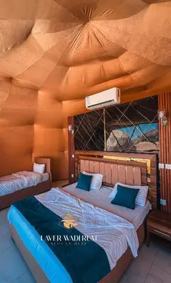 two beds in a room with a roof at Laver wadi rum in Wadi Rum