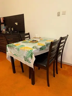 a dining room table with a table and two chairs at Abdallah Wa'el Adham in Aqaba