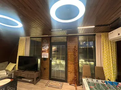 a living room with a television and a couch at Umm Aljulud Cottages 02 in Ajloun