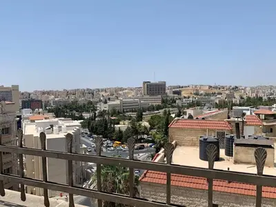a view of a city from a balcony at City View Rooftop Apartment Amman in Amman