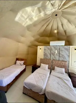 a room with two beds and a ceiling at Rum Desert Silence Camp in Wadi Rum