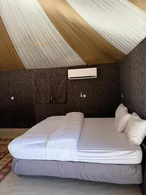 a large bed in a room with a ceiling at NAJMA lUXURY CAMP in Wadi Rum
