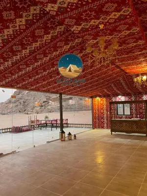 a pavilion with a table and a sign on the ceiling at Giulia Rum Luxury Camp in Wadi Rum