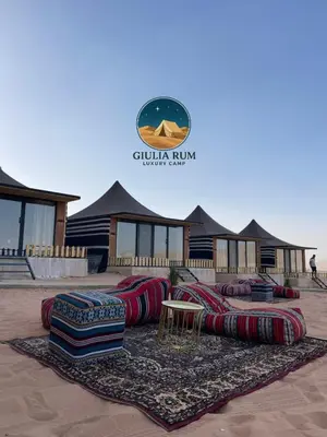 a group of pillows sitting in front of a building at Giulia Rum Luxury Camp in Wadi Rum