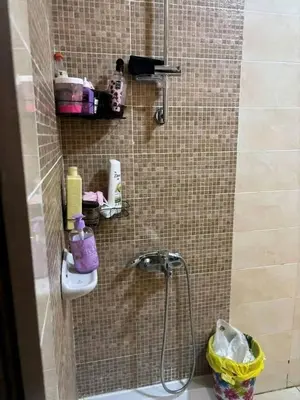 a bathroom with a shower with a sink at Vrtn hotel in Amman