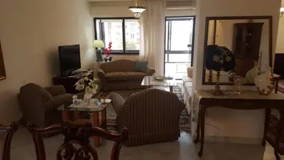 a living room with a couch and a table at Abdoun rose in Amman