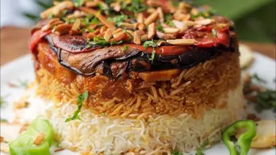 a piece of food on a plate with rice at Petra House for Traditional Jordanian Food in Petra