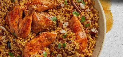 a pan of food with chicken and rice at Petra House for Traditional Jordanian Food in Petra