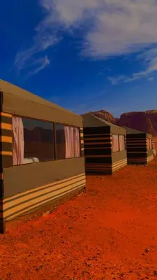 a row of tents in the middle of the desert at Rum Tale Camp in Wadi Rum