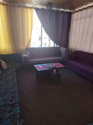 a living room with a couch and a table at Petra Bed Hostel in Petra