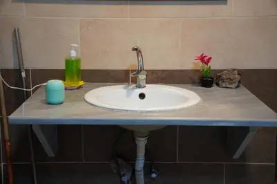 a bathroom counter with a white sink and a sink at Petra sharing room in Petra