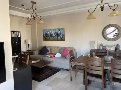 a living room with a couch and a table at Luxury Apartment for Daily Rent in Shmaisani in Amman