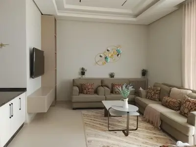 a living room with a couch and a table at كمباوند شقة مفروشة كومباوند الامعري المطار in Amman