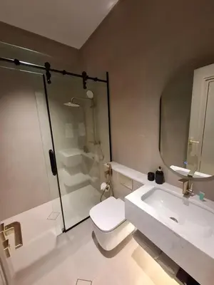 a bathroom with a shower and a toilet and a sink at كمباوند شقة مفروشة كومباوند الامعري المطار 222 in Amman