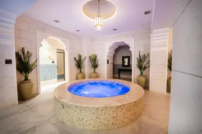 a large bathroom with a large blue tub in a room at كمباوند شقة مفروشة كومباوند الامعري المطار 222 in Amman