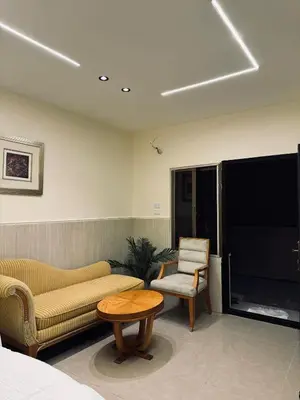 a room with a couch and a table and a chair at The cava in Amman