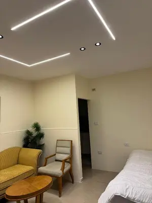 a bedroom with a bed and a couch and a table at The cava in Amman