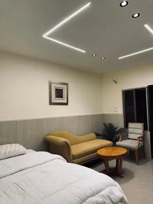 a bedroom with a bed and a table and chairs at The cava in Amman