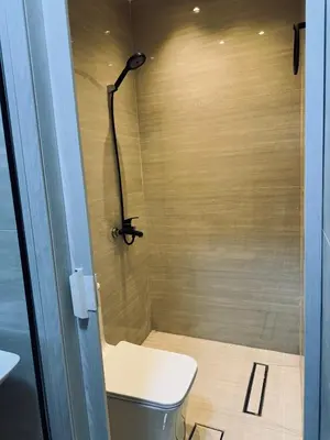 a small bathroom with a toilet and a shower at The cava in Amman