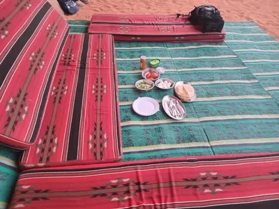 a close up of a table with some plates at Ayed Wadi Rum camp in Wadi Rum