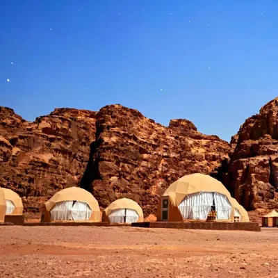 a group of domes in the desert with rocks at Desert Oasis in Wadi Rum Village - Cozy Lodge Room in Aqaba