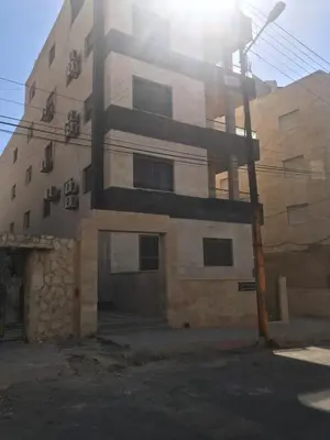 a building with the sun shining on it at Fully Furnished apartment for rent in Amman Khalda in Amman