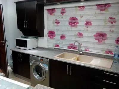 a kitchen with a sink and a washing machine at Fully Furnished apartment for rent in Amman Khalda in Amman