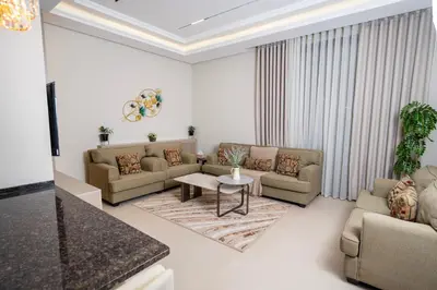 a living room with couches and a table at طريق المطار بوليفارد الامعري in Amman