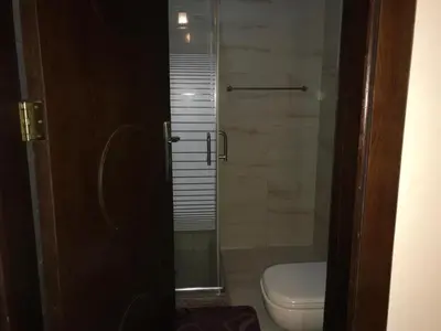 a bathroom with a toilet and a glass shower at luxury apartment in amman, abdoun in Amman