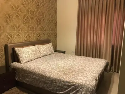 a bedroom with a bed with a pillow and a window at luxury apartment in amman, abdoun in Amman