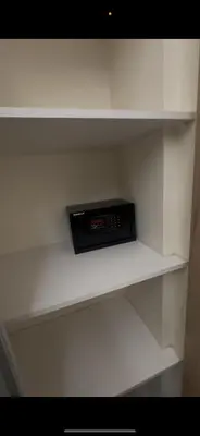 a shelf in a closet with a clock on it at السلام للشقق الفندقية peace hotel apartments in Aqaba