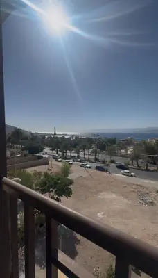 a view from a balcony of a parking lot at السلام للشقق الفندقية peace hotel apartments in Aqaba