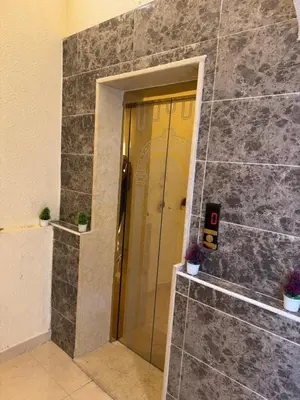 a door in a stone wall with two potted plants at السلام للشقق الفندقية peace hotel apartments in Aqaba