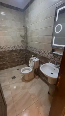 a bathroom with a toilet and a sink at السلام الشقق الفندقية peace hotel apartments in Aqaba