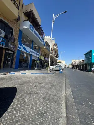 an empty street in a city with buildings at السلام الشقق الفندقية peace hotel apartments in Aqaba