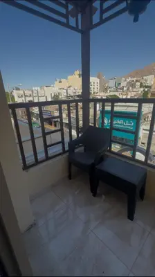 a view of a balcony with a chair and a table at السلام الشقق الفندقية peace hotel apartments in Aqaba
