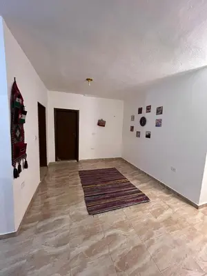 an empty living room with a rug on the floor at Peace House in Wadi Musa