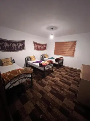 a room with two beds and a couch at Peace House in Wadi Musa