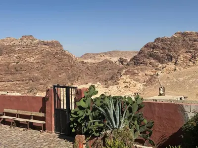 a gate in the desert with mountains in the background at Peace House in Wadi Musa
