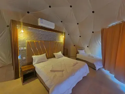 a bedroom with two beds in a tent at Lunar scape haven in Wadi Rum