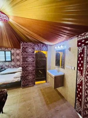 a bedroom with a bed and a sink in a room at Lunar scape haven in Wadi Rum