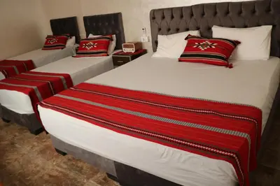 two beds in a room with red pillows on them at Premium apartment Section A in Wadi Musa