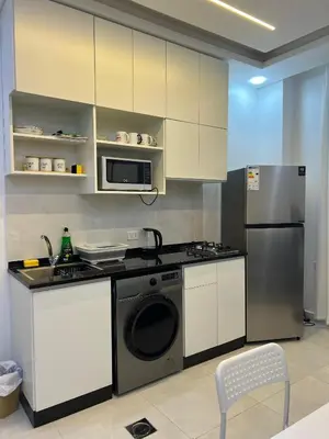 a kitchen with a stove and a refrigerator at Nice place in Irbid