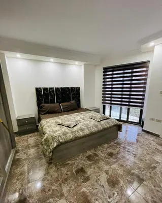 a bedroom with a bed and a large window at New studio in Jabal Amman and Al-Weibdeh متابعة in Amman