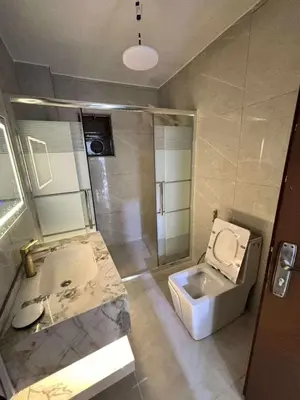 a bathroom with a toilet and a sink and a shower at Miami Luxe Apartment ماركا