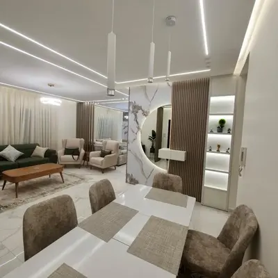 a living room with a white table and chairs at Cozy 3BR Apartment by 7th Circle in Amman