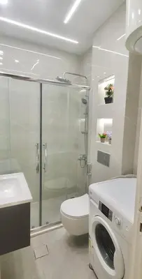 a bathroom with a shower and a toilet and a sink at Cozy 3BR Apartment by 7th Circle in Amman
